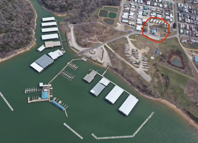 Aerial view of a marina with the location of The Twisted Anchor Grill & Patio marked by a red circle.